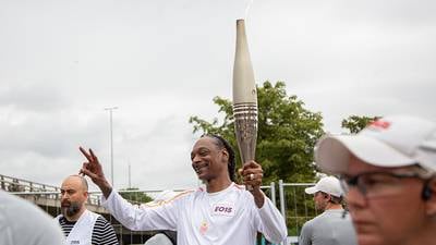 Snoop Dogg Dances the Olympic Torch Through Paris Ahead of Opening Ceremony