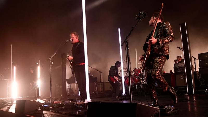 Queens of the Stone Age performing on stage