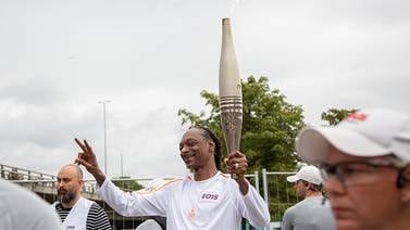 Snoop Dogg Dances the Olympic Torch Through Paris Ahead of Opening Ceremony