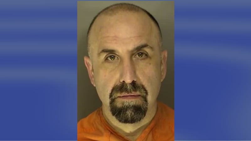 Former detective Michael DeBiase was booked on a felony charge of pointing and presenting a firearm at a person.